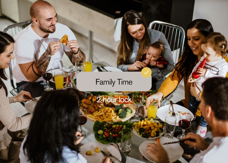 Family together at the dinner table, phones away