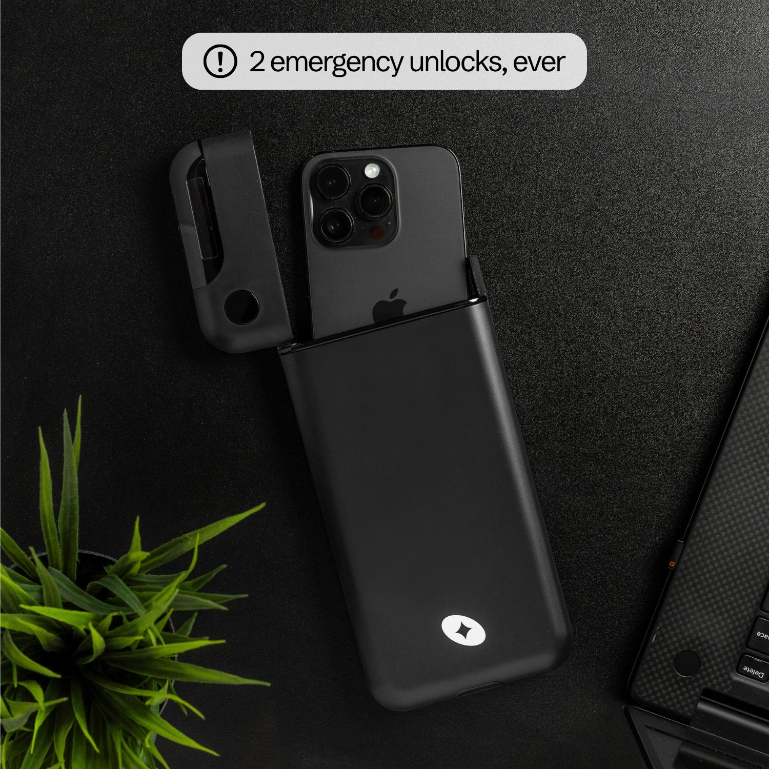 Flat lay of a phone sliding out of the open Lockbox — 2 emergency unlocks, ever