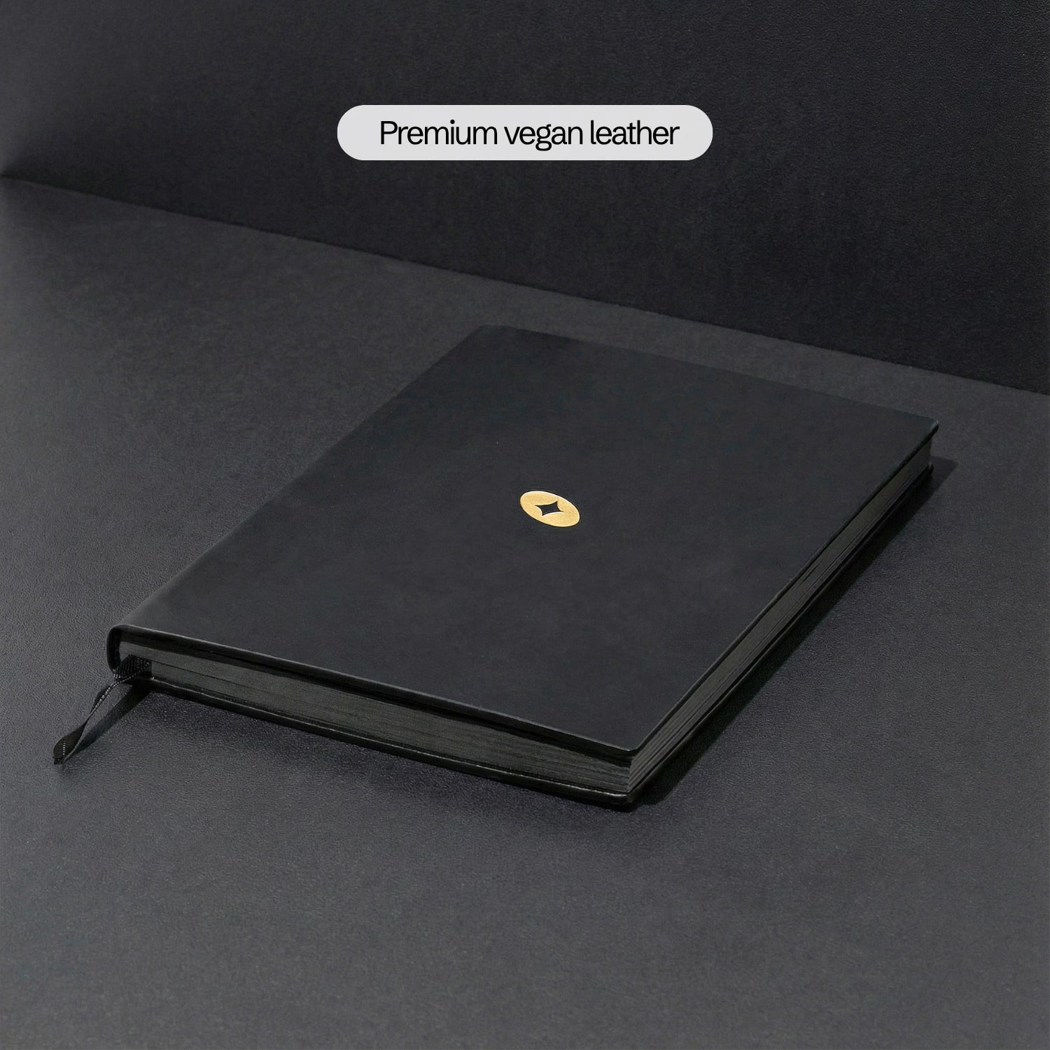 The Notebook v1.0 — black vegan leather hardback with gold foil emblem
