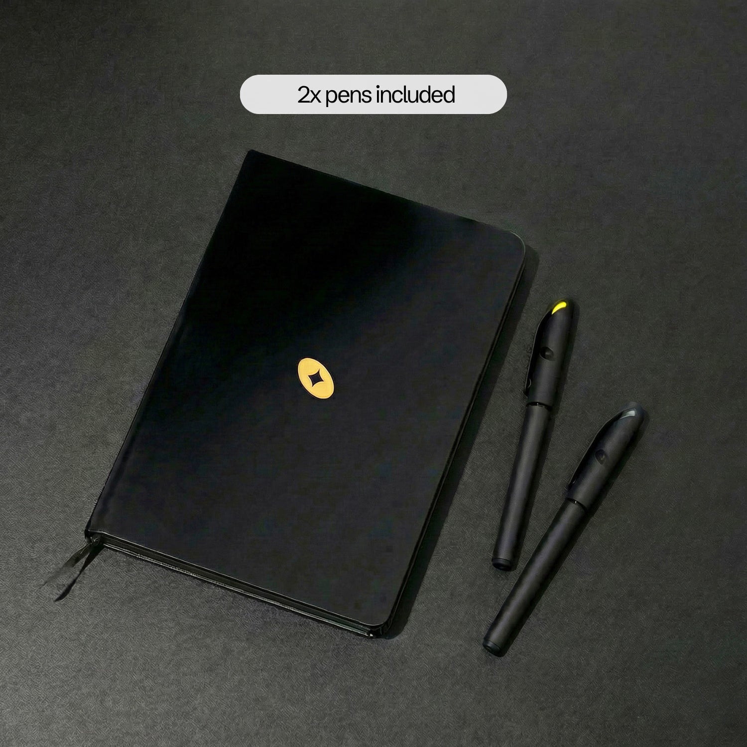 The Notebook with the two included gel pens — one silver, one gold